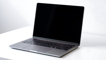Sleek silver laptop open with dark screen and keyboard image