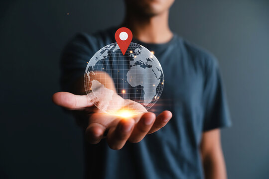 Man holding a glowing digital globe with a location pin