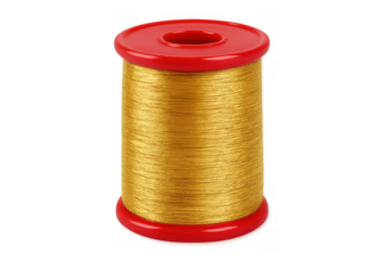 Golden thread spool, red plastic caps, isolating transparent background, highlighting crafting and textile creativity