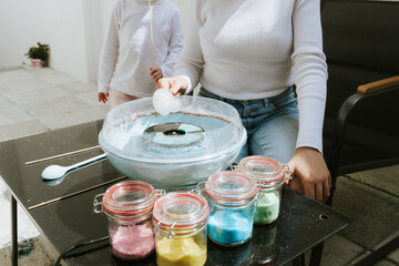 Girls make cotton candy in their backyard.