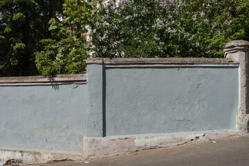 Old abandoned concrete city fence.