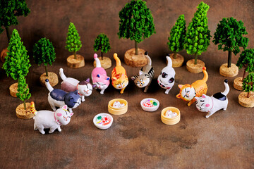 Cats of different colors run to taste a treat on their holiday - International Cat Day.