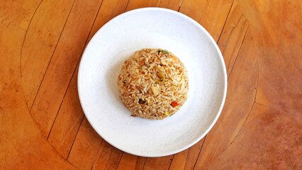 Seafood fried rice served on white plate isolated on white background. Food presentation business