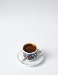 Savor rich Turkish coffee with traditional decorative cup and sweet sugar cubes on white background