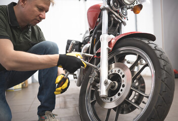 Man Repairs Classic Motorcycle In Garage