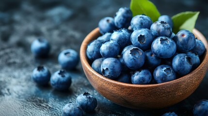 Fresh ripe blueberries overflowing from wooden bowl on rustic table