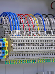 Electrical terminals with connected insulated copper wires with metal lugs. Marking with a thermal...