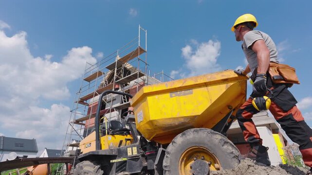 Construction Worker Operates Loader at a Busy Building Site During Sunny Day