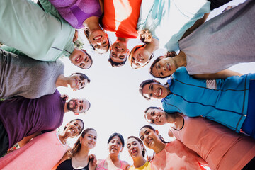 Diverse group of latin people in Circle Looking Down at Camera in sport wear after running training...