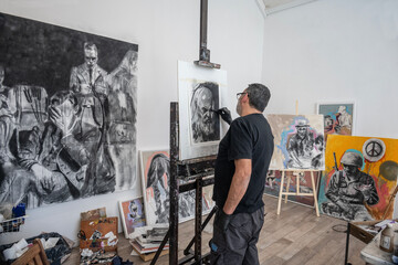 Artist in his painting studio, in Villa Giardino, Córdoba, Argentina.