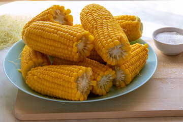 Cooked sweet corn on cob closeup on table. Organic golden maize. Vegetarian healthy snack concept. Focus Stacking