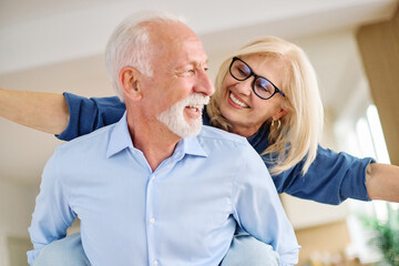 Happy active senior couple having fun at home. Portrait of an elderly couple together