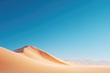 golden sand dunes undulating under clear blue sky