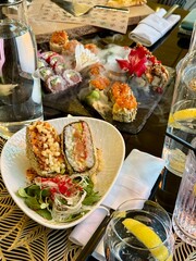 Elegant Sushi Platter with Smoke Presentation and Fresh Greens at Fine Dining Restaurant

