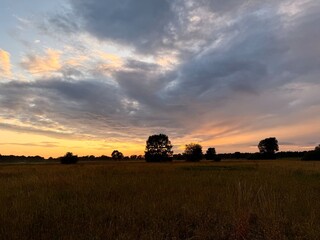 fantastic sunset in the field, twilights sky in the summer field