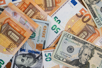 Dollar banknotes and euro bills placed on table demonstrate concept of exchange rate between major...