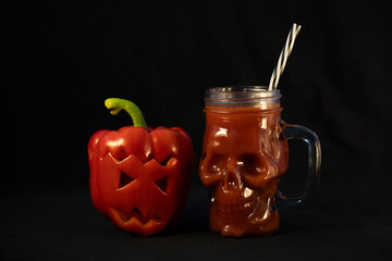 Jack o lantern bell pepper and a blood-red drink. Skull-shaped mug