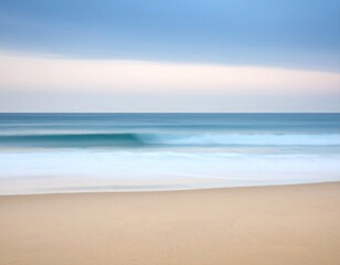 Gentle ocean waves on a beach at dawn