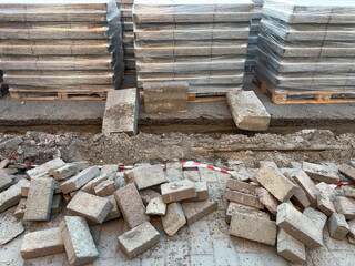 Removing old paving stones and curbstone, installing new ones