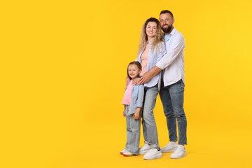 Happy family on yellow background. Space for text
