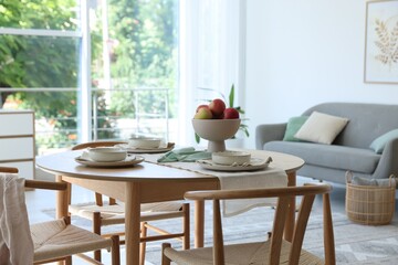 Stylish table setting, chairs and decor in dining room. Interior design