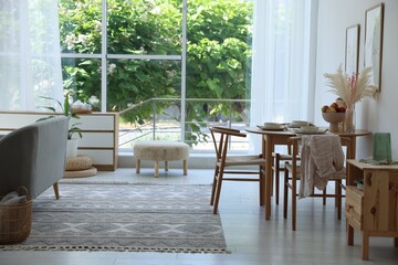 Stylish table setting, chairs and decor in dining room. Interior design