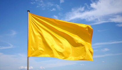 Yellow flag waving in a clear blue sky