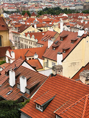 Fototapeta premium Abstract Geometric Pattern From Roofs of Old Town With Orange Colored Shingle With White Chimneys 