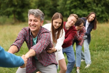 Fototapeta premium Team building. Group of happy people holding hands outdoors