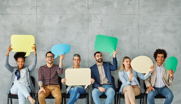 Portrait of a group of young business people in office. Speech bubble, team and comment by business people holding sign, news and voice icon feeling excited on social media. Group, opinion and poll by
