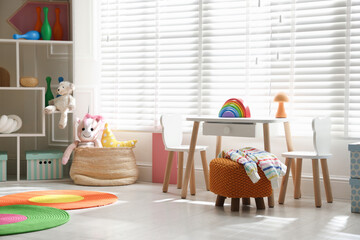 Stylish playroom with toys and furniture. Interior design