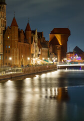 Gdańsk waterfront at night with Żuraw Crane and cloudy sky © Dreamnordno