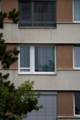 Windows filter routine. Blinds obscure rhythm. Branches soften order. Texture hides repetition.

