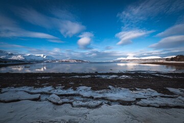 Serene winter landscape with snow-covered mountains.