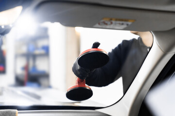 Windshield replacement using lifting tools that grip glass securely. Windshield technicians rely on...
