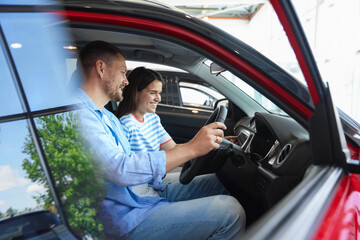 Happy family sitting inside new car. Luxury vehicle