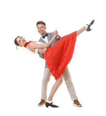 Happy couple in retro outfits dancing on white background