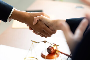 Obraz premium Handshake Agreement. Diverse professionals sealing a deal in a law office.