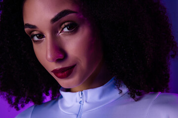 Close up of a young African girl in neon lighting, dressed stylishly with bold makeup, exuding...