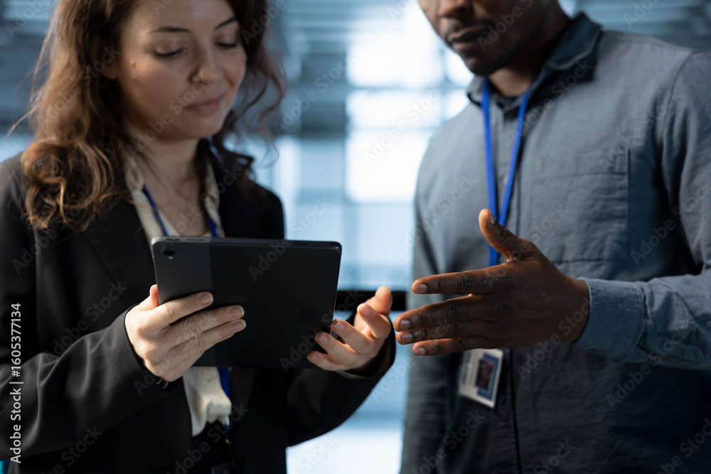 Poster team of technicians in data center automating routine maintenance tasks with tablet, executing diagn