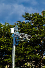 Urban surveillance and traffic monitoring cameras on metal poles in Brazil. Devices help improve public safety, vehicle control, and city management through smart technology.