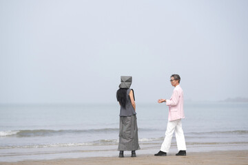 In June 2025, a Korean man and woman in their late fifties are standing and talking beside the...