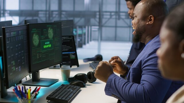 Data scientists receive access granted notification while reconfiguring server hub, optimizing it. Team of IT experts ensures data center operates efficiently, successfully eliminating all errors - Powered by Adobe