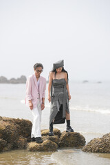 In June 2025, a Korean man and woman in their late fifties are standing and talking beside the...