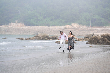 In June 2025, a Korean man and woman in their late fifties are running at full speed along the...