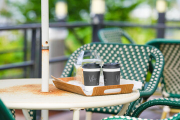 In Incheon, a fashionable beachside cafe terrace with elegant parasols, cozy chairs, and scenic...
