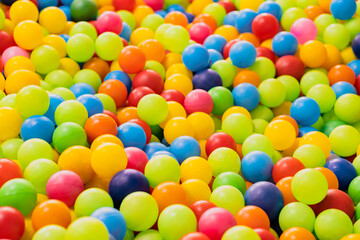 A sea of colorful plastic balls fills a childrens play area inviting kids to jump in and enjoy the vibrant atmosphere Sunlight enhances the playful setting creating joy