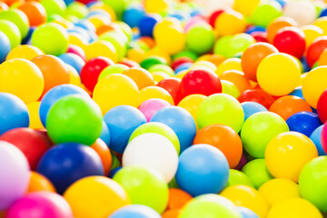 A sea of colorful plastic balls fills a childrens play area inviting kids to jump in and enjoy the vibrant atmosphere Sunlight enhances the playful setting creating joy