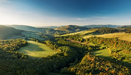 stunning aerial view over valley with rural countryside woodland forest