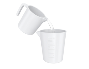 Liquid streams from one container into another, ready for measuring and cooking.